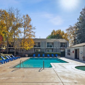 Shimmering resort-style pool a swimming pool and hot tub behind a building