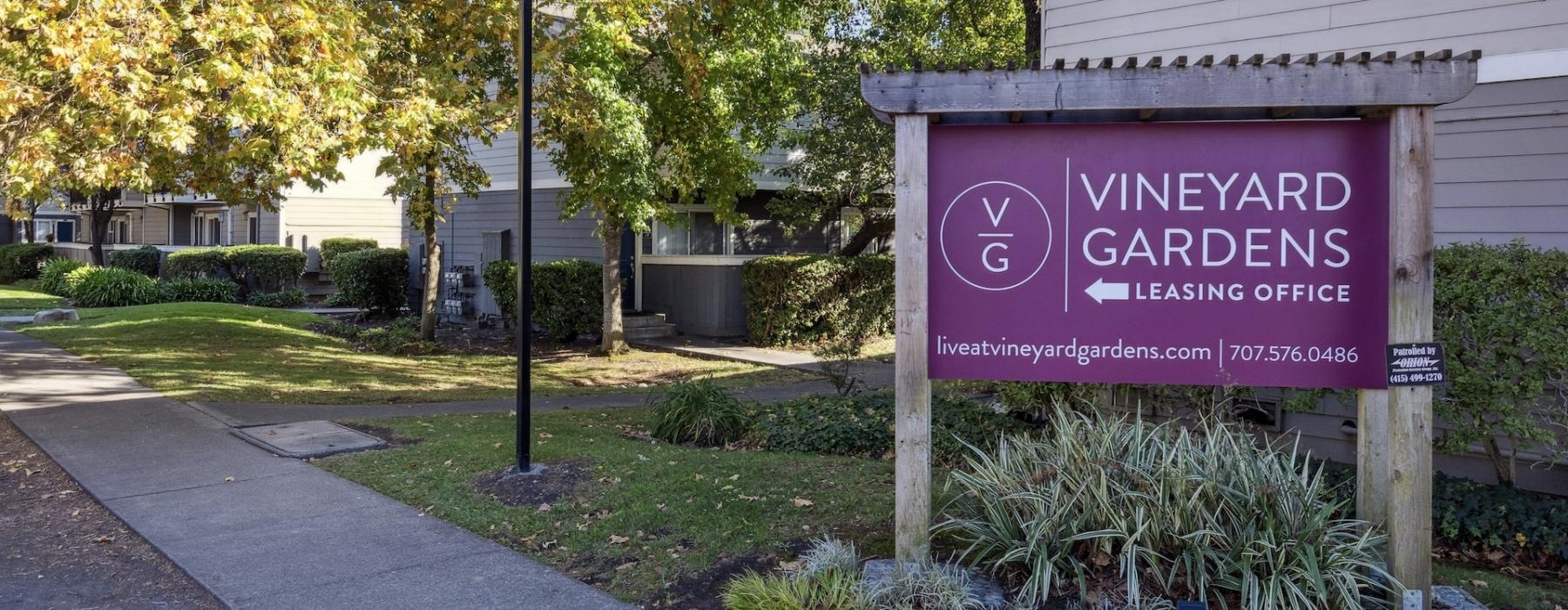 a sign in front of a building that reads vineyard gardens