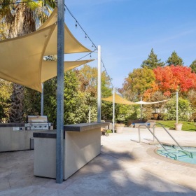 Find your perfect fit at Vineyard Gardens a hot tub with a covered grill area next to it